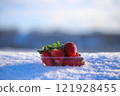 Packed strawberries on snow 121928455