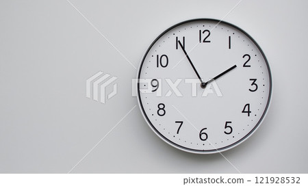 Minimalist Analog Wall Clock with White Face and Simple Black Hands Showing 13.55/01.55 - Ideal for Time Management and Modern Decor Concepts 121928532