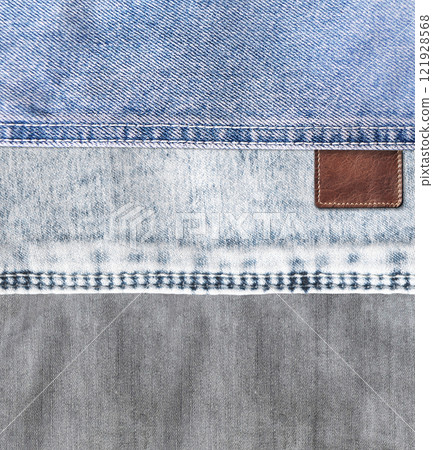 Vertical background with blue and gray denim texture with a seam and old leather label. Jeans material of blue and grey color and vintage tag of brown color. Mock up template. Copy space for text 121928568