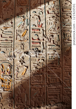Sunrays illuminate the wall in the tomb in the valley of the Kings, Luxor, Egypt. Ancient Egyptian hieroglyphs on stone wall with sunlit areas Sunrays illuminate the wall in the tomb in the valley of the Kings, Luxor, Egypt. Ancient Egyptian hieroglyphs on stone wall with sunlit areas 121928591