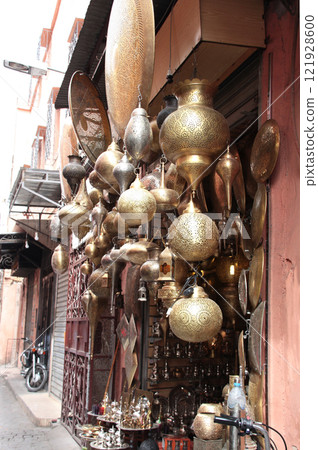 Street shop of moroccan metal lamps and traveller souvenirs in medina of Marrakech, Morocco. Traditional moroccan tourist brass souvenirs on market street Street shop of moroccan metal lamps and traveller souvenirs in medina of Marrakech, Morocco. Traditional moroccan tourist brass souvenirs on market street 121928600