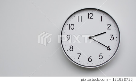 Minimalist Analog Wall Clock with White Face and Simple Black Hands Showing 14.20/02.20 - Ideal for Time Management and Modern Decor Concepts 121928733