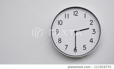 Minimalist Analog Wall Clock with White Face and Simple Black Hands Showing 14.30/02.30 - Ideal for Time Management and Modern Decor Concepts 121928735