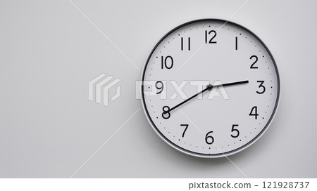 Minimalist Analog Wall Clock with White Face and Simple Black Hands Showing 14.40/02.40 - Ideal for Time Management and Modern Decor Concepts 121928737