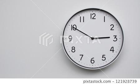 Minimalist Analog Wall Clock with White Face and Simple Black Hands Showing 14.50/02.50 - Ideal for Time Management and Modern Decor Concepts Minimalist Analog Wall Clock with White Face and Simple Black Hands Showing 14.50/02.50 - Ideal for Time Management and Modern Decor Concepts 121928739