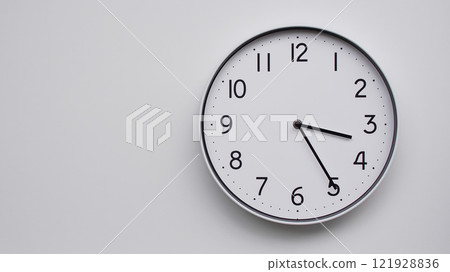 Minimalist Analog Wall Clock with White Face and Simple Black Hands Showing 15.25/03.25 - Ideal for Time Management and Modern Decor Concepts 121928836