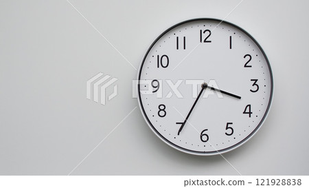 Minimalist Analog Wall Clock with White Face and Simple Black Hands Showing 15.35/03.35 - Ideal for Time Management and Modern Decor Concepts Minimalist Analog Wall Clock with White Face and Simple Black Hands Showing 15.35/03.35 - Ideal for Time Management and Modern Decor Concepts 121928838