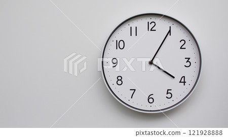 Minimalist Analog Wall Clock with White Face and Simple Black Hands Showing 16.05/04.05 - Ideal for Time Management and Modern Decor Concepts Minimalist Analog Wall Clock with White Face and Simple Black Hands Showing 16.05/04.05 - Ideal for Time Management and Modern Decor Concepts 121928888