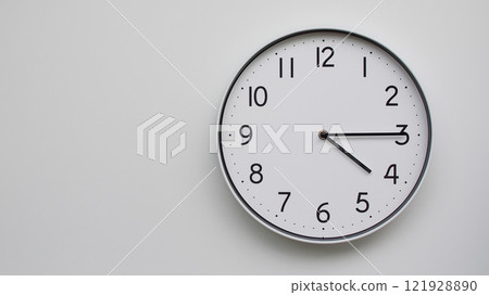 Minimalist Analog Wall Clock with White Face and Simple Black Hands Showing 16.15/04.15 - Ideal for Time Management and Modern Decor Concepts Minimalist Analog Wall Clock with White Face and Simple Black Hands Showing 16.15/04.15 - Ideal for Time Management and Modern Decor Concepts 121928890