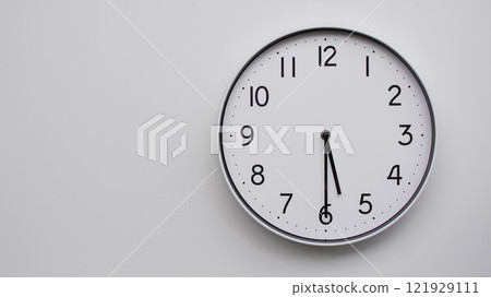Minimalist Analog Wall Clock with White Face and Simple Black Hands Showing 17.30/05.30 - Ideal for Time Management and Modern Decor Concepts 121929111