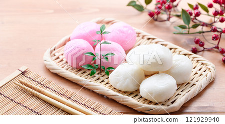 Red and white round rice cakes on a basket Red and white round rice cakes on a basket 121929940