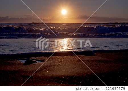 Winter sunrise seen from the sea 121930679