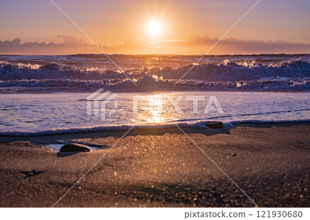 Winter sunrise seen from the sea 121930680