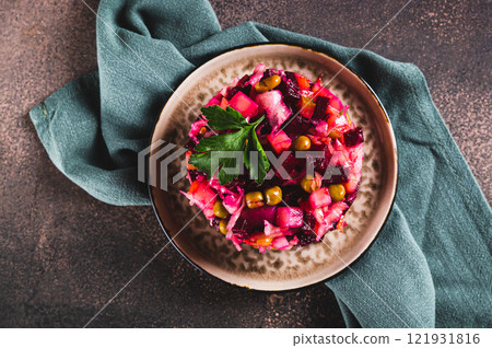 Close up of traditional beetroot salad with boiled vegetables and pickles on a plate top view 121931816