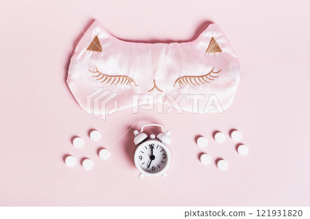 Concept insomnia sleep mask, sleeping pills and alarm clock on pink background Concept insomnia sleep mask, sleeping pills and alarm clock on pink background 121931820