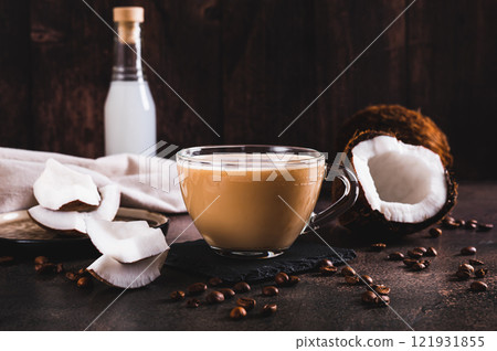 Vietnamese coconut coffee in a cup and coconut pieces on the table Vietnamese coconut coffee in a cup and coconut pieces on the table 121931855