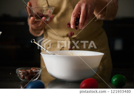 Preparing homemade dessert with chocolate and berries during festive holidays Preparing homemade dessert with chocolate and berries during festive holidays 121933480