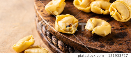 Fresh Tortellini Cappelletti Pasta on Wooden Board 121933727