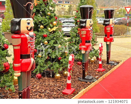 Christmas composition on street. Decorated Christmas tree and wooden nutcrackers. Holidays and decoration. Christmas composition on street. Decorated Christmas tree and wooden nutcrackers. Holidays and decoration. 121934071
