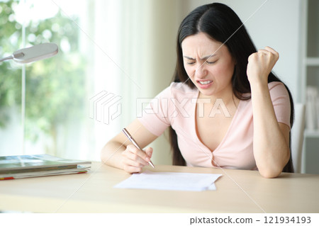 Angry asian woman reading contract before sign it 121934193