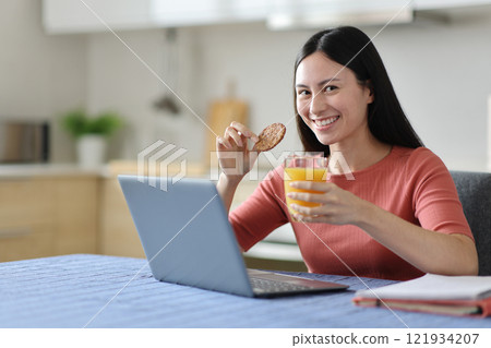 Happy asian student posing in the kitchen at breakfast 121934207