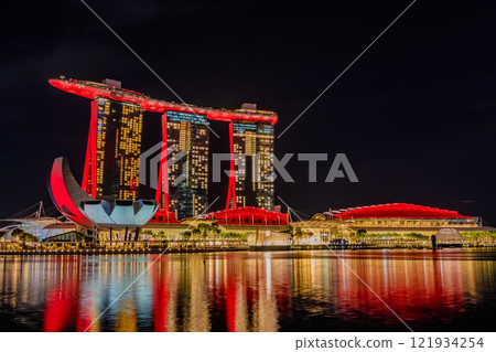 Singapore's icon, Marina Bay Sands, illuminated in red as seen from Merlion Park Singapore's icon, Marina Bay Sands, illuminated in red as seen from Merlion Park 121934254