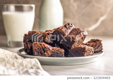 Homemade chocolate brownies on plate on kitchen table. Homemade chocolate brownies on plate on kitchen table. 121934403