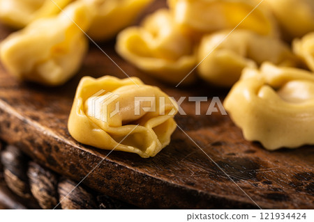 Fresh Tortellini Cappelletti Pasta on Wooden Board 121934424