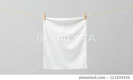 Hanging white fabric on a clothesline in a bright indoor setting during daylight hours 121934550