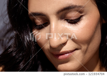 studio portrait of an attractive young woman on a gray background 121934704