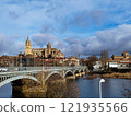 Salamanca. View of Salamanca and the Enrique Estevan bridge from the dock viewing point over the Tormes River. Traditional stone buildings. Salamanca Cathedral. SALAMANCA, SPAIN. 13 JANUARY 2025. 121935566