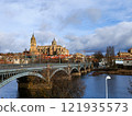 Salamanca. View of Salamanca and the Enrique Estevan bridge from the dock viewing point over the Tormes River. Traditional stone buildings. Salamanca Cathedral. SALAMANCA, SPAIN. 13 JANUARY 2025. 121935573