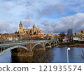 Salamanca. View of Salamanca and the Enrique Estevan bridge from the dock viewing point over the Tormes River. Traditional stone buildings. Salamanca Cathedral. SALAMANCA, SPAIN. 13 JANUARY 2025. 121935574