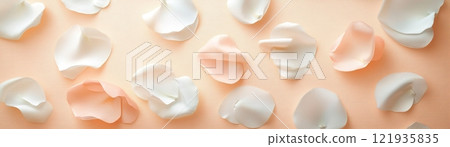 Delicate pink and white flower petals scattered on a soft pastel background for elegant design projects 121935835