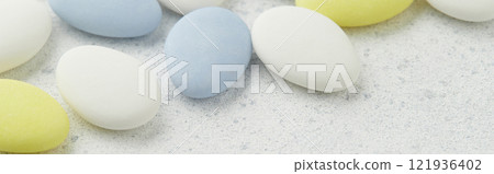 Traditional Easter Portuguese candies. White, yellow and blue sweets on grey background 121936402