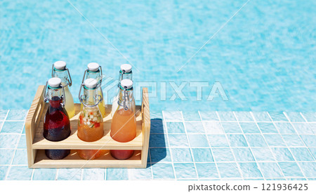 Close-up of a wooden box with glass bottles on the side of the pool. Delicious chilled multicolored drinks on a background of clear blue water. Bright natural sunlight. 121936425