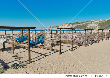 Traditional fish-drying on the beach of Nazare, Portugal Traditional fish-drying on the beach of Nazare, Portugal 121936504