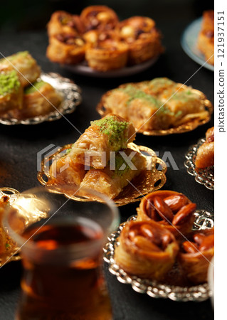 Delicious assortment of traditional pastries served on ornate platters with tea Delicious assortment of traditional pastries served on ornate platters with tea 121937151
