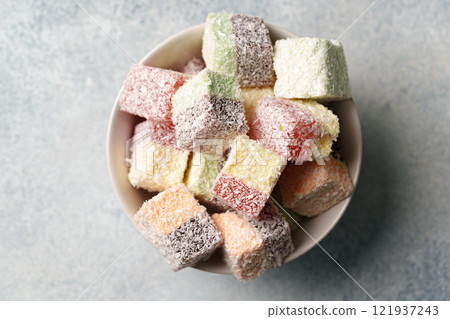 Colorful cubes of sweet confectionery arranged in a bowl ready for sharing at a gathering or celebration 121937243