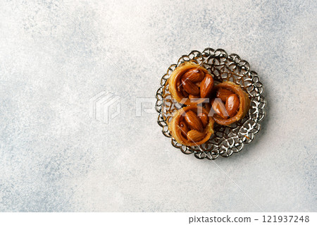 Traditional pastry displayed on an ornate plate showcasing cultural dessert craftsmanship 121937248