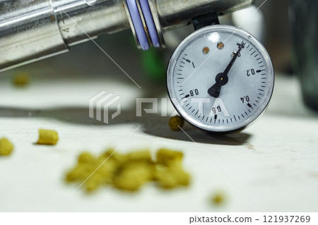 A pressure gauge reads 0.2, surrounded by small, yellow pellets A pressure gauge reads 0.2, surrounded by small, yellow pellets 121937269