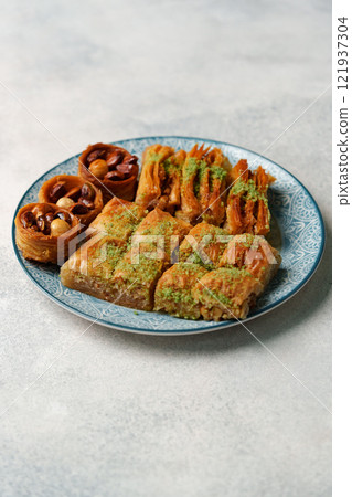 Delicious assortment of traditional pastries on decorative plate showcasing rich flavors and textures Delicious assortment of traditional pastries on decorative plate showcasing rich flavors and textures 121937304