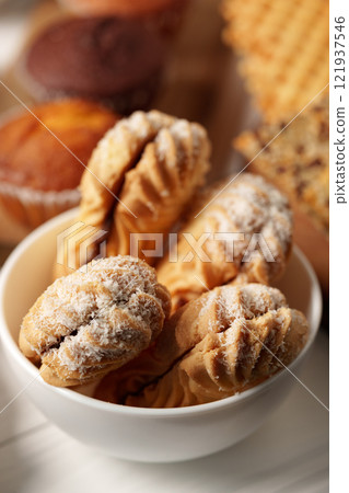 Tasty homemade pastries arranged in a bowl, ideal for dessert lovers and special occasions 121937546