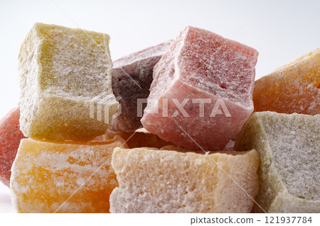 Colorful cubes of Turkish delight stacked in an appetizing display at a confectionery shop Colorful cubes of Turkish delight stacked in an appetizing display at a confectionery shop 121937784