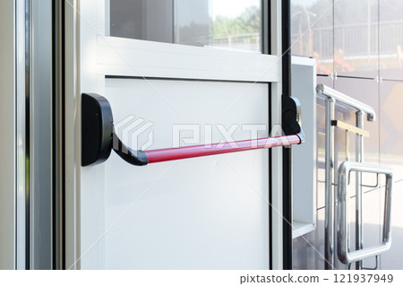 Door handle installation in a modern public building with safety features 121937949