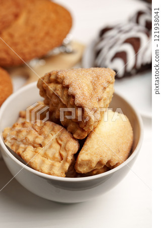 Delicious assorted cookies displayed in a bowl, showcasing their unique shapes and textures for an inviting treat Delicious assorted cookies displayed in a bowl, showcasing their unique shapes and textures for an inviting treat 121938041