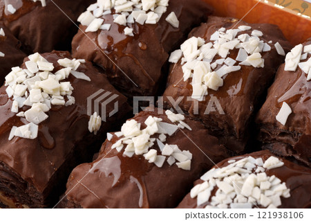 Delicious chocolate desserts topped with coconut flakes at a bakery display 121938106
