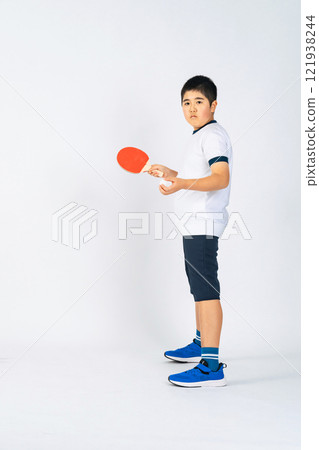 Full body photo of a boy holding a table tennis racket Full body photo of a boy holding a table tennis racket 121938244