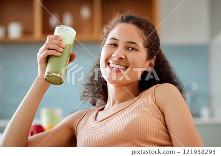 Green smoothie, drink and healthy juice for weight loss, detox or breakfast diet in home living room. Portrait of smiling, happy woman drinking fruit or vegetarian beverage with vitamins or nutrition Green smoothie, drink and healthy juice for weight loss, detox or breakfast diet in home living room. Portrait of smiling, happy woman drinking fruit or vegetarian beverage with vitamins or nutrition 121938293