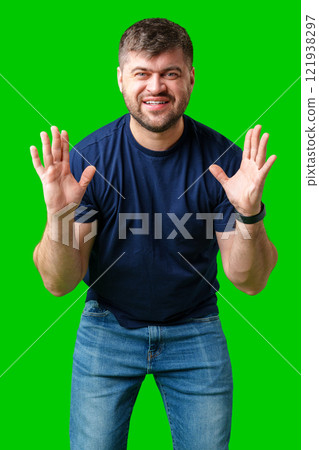 A surprised man expresses shock against a bright green background A surprised man expresses shock against a bright green background 121938297